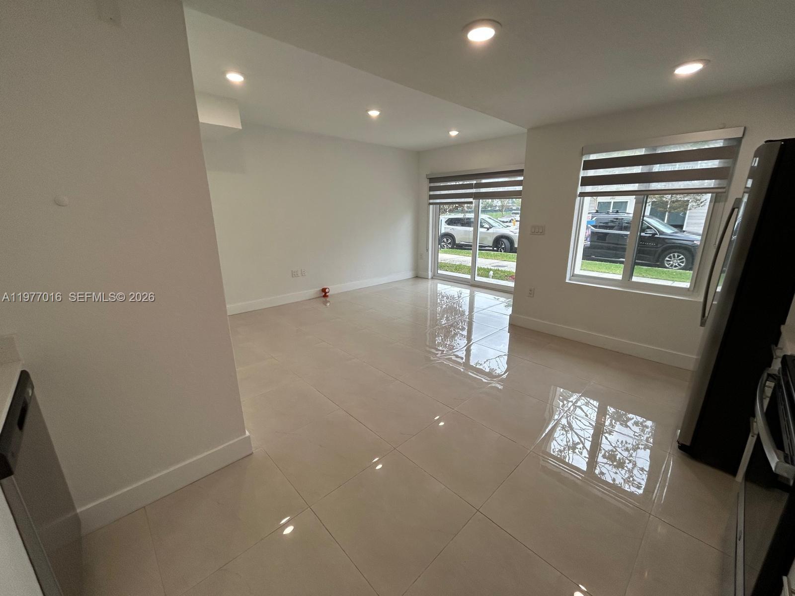 25814 Southwest 144th Court, Unit 2 Homestead, FL 33032 - Photo 5 of 25 en empty room with windows