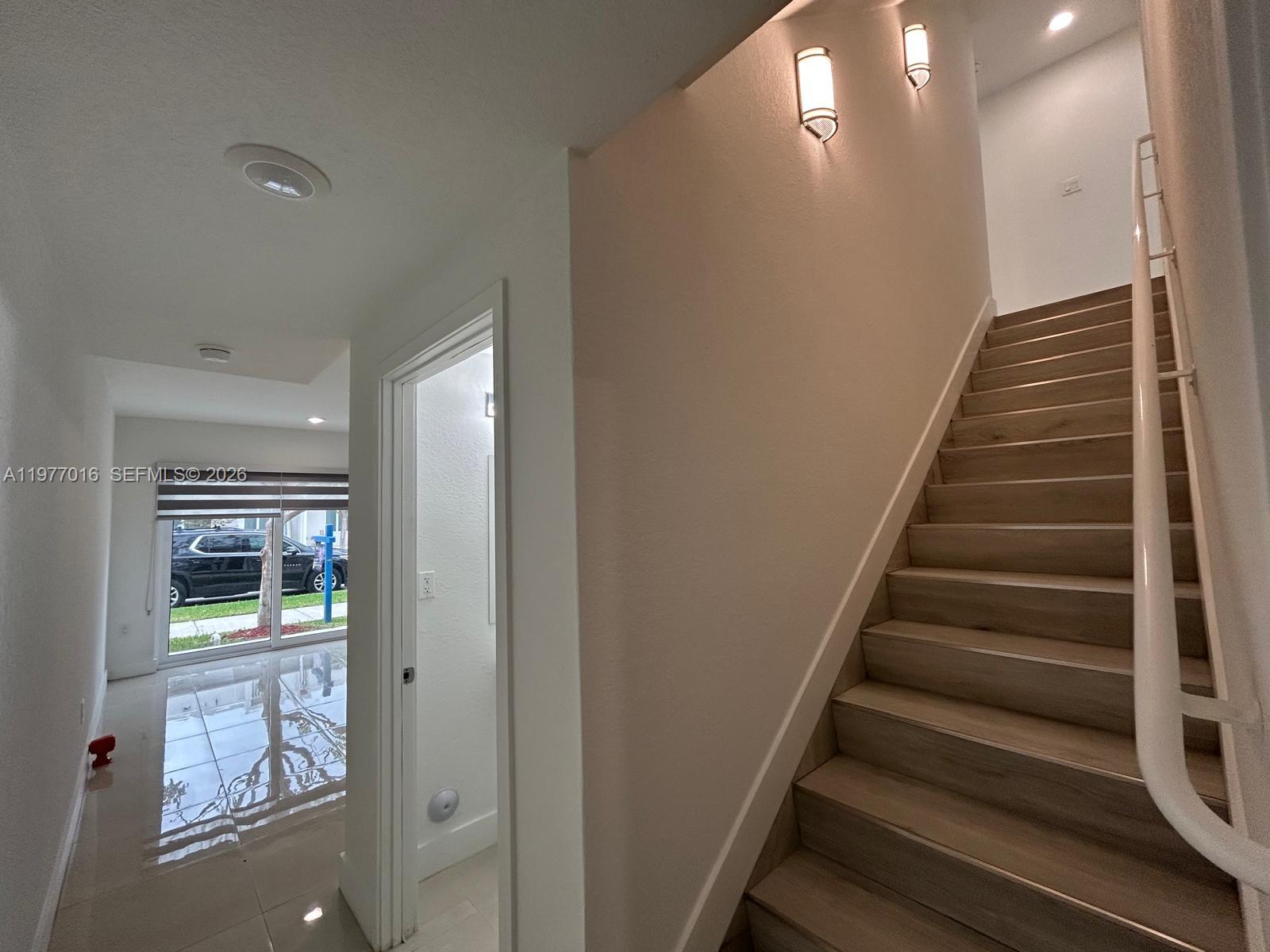 25814 Southwest 144th Court, Unit 2 Homestead, FL 33032 - Photo 7 of 25 a view of entryway and hall with wooden floor