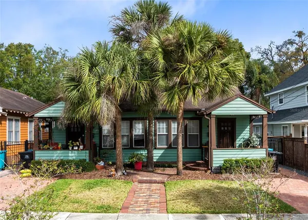front view of a brick house with a yard