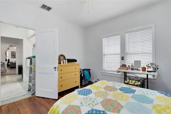 a bedroom with a bed and a dresser