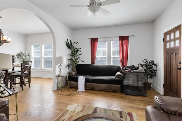 a living room with furniture and wooden floor