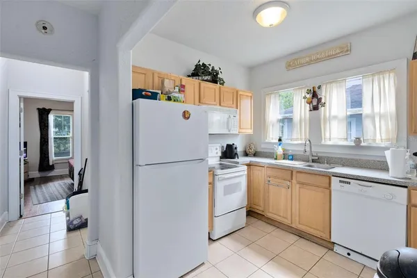 a white refrigerator freezer sitting inside of a kitchen