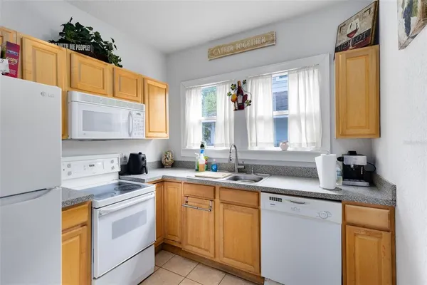 a kitchen with a sink a window and cabinets