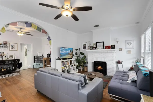 a living room with furniture a fireplace and a flat screen tv