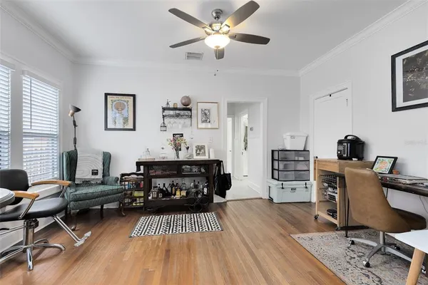 a living room with furniture a piano and a flat screen tv