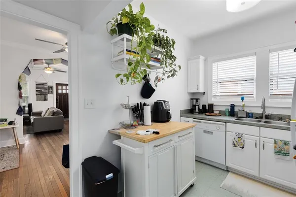 a view of kitchen and sink with wooden floor