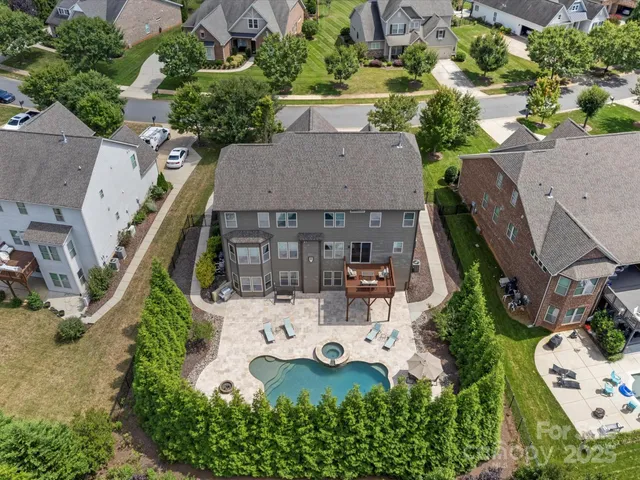 an aerial view of a house with yard and lake view