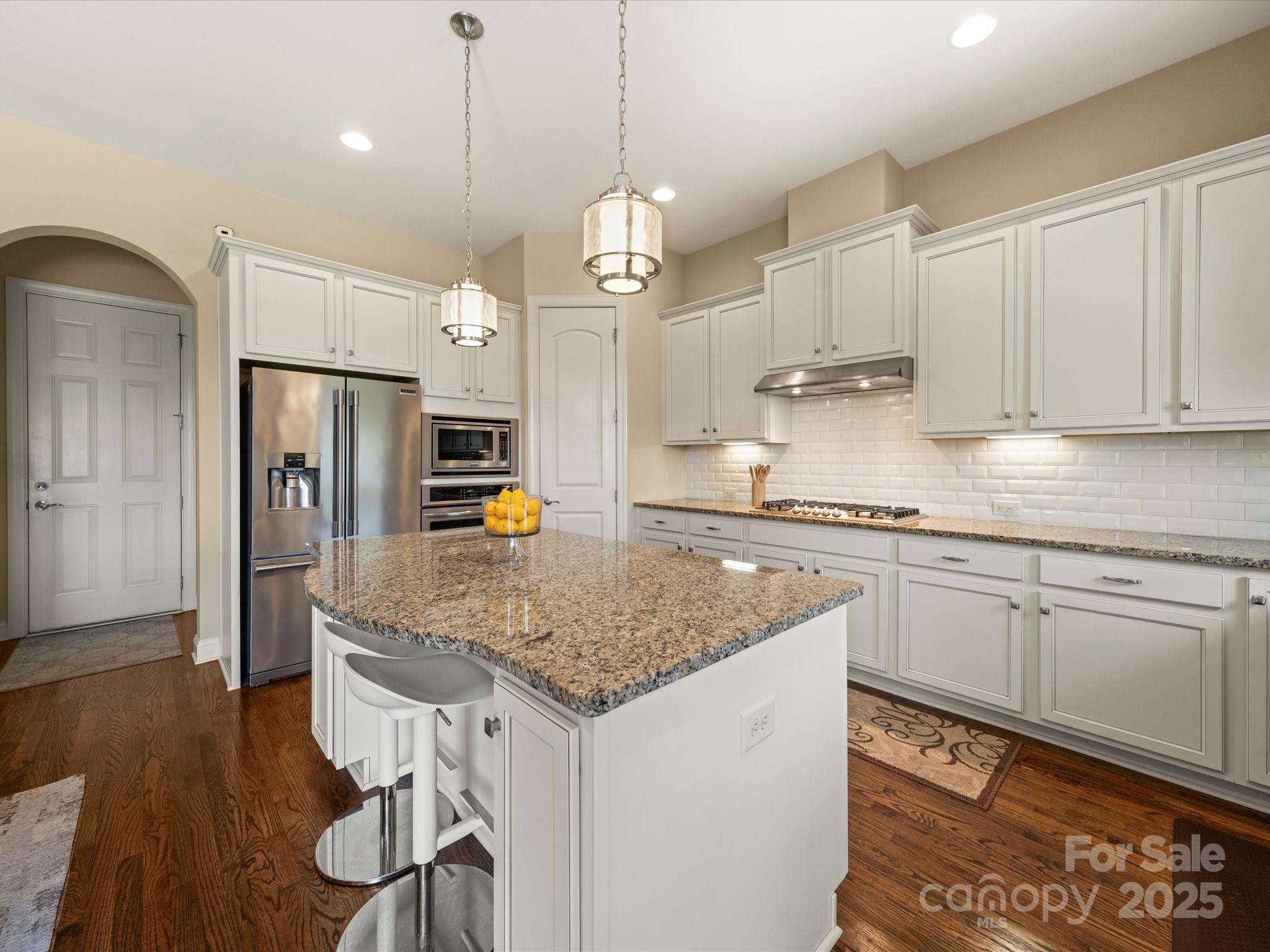 11632 Barnard Street Mint Hill, NC 28227 - Photo 11 of 39 a kitchen with stainless steel appliances granite countertop a sink refrigerator and cabinets