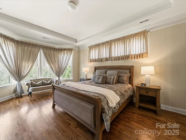 a bedroom with a bed and a television