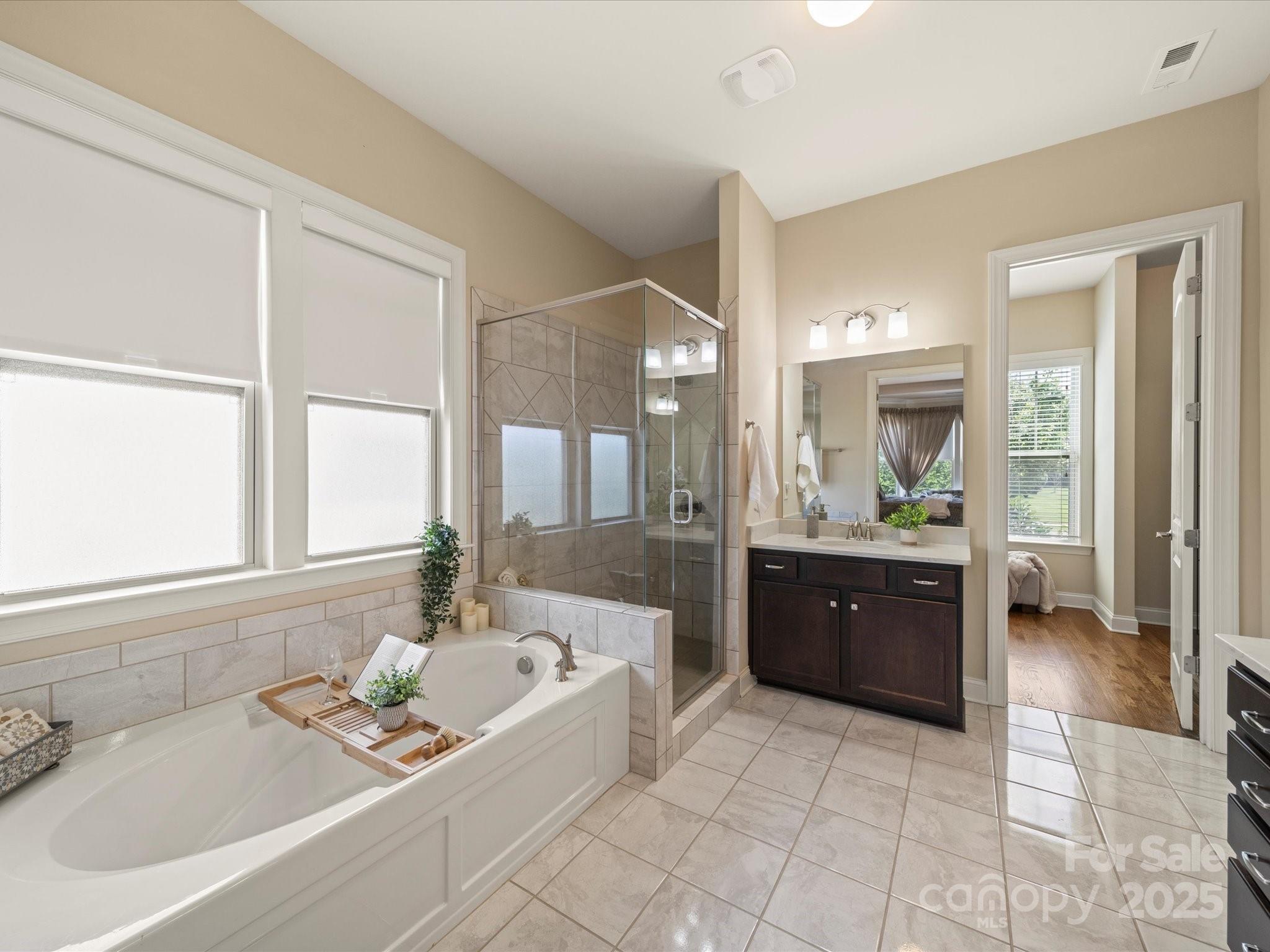 11632 Barnard Street Mint Hill, NC 28227 - Photo 15 of 39 a spacious bathroom with a tub sink and mirror