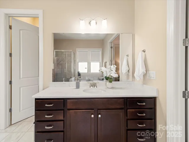 a bathroom with a tub sink and mirror