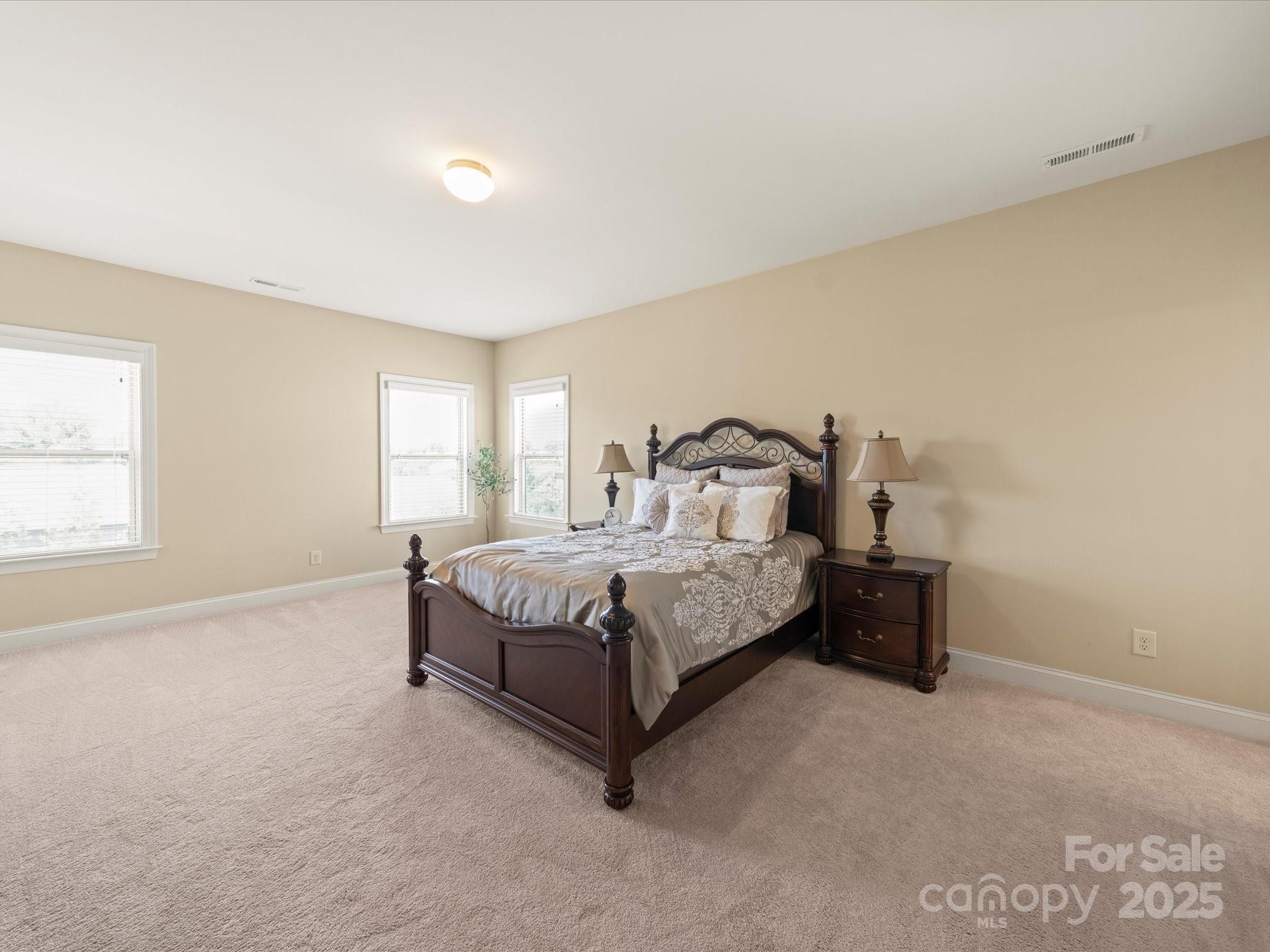 11632 Barnard Street Mint Hill, NC 28227 - Photo 24 of 39 a spacious bedroom with a bed and a window