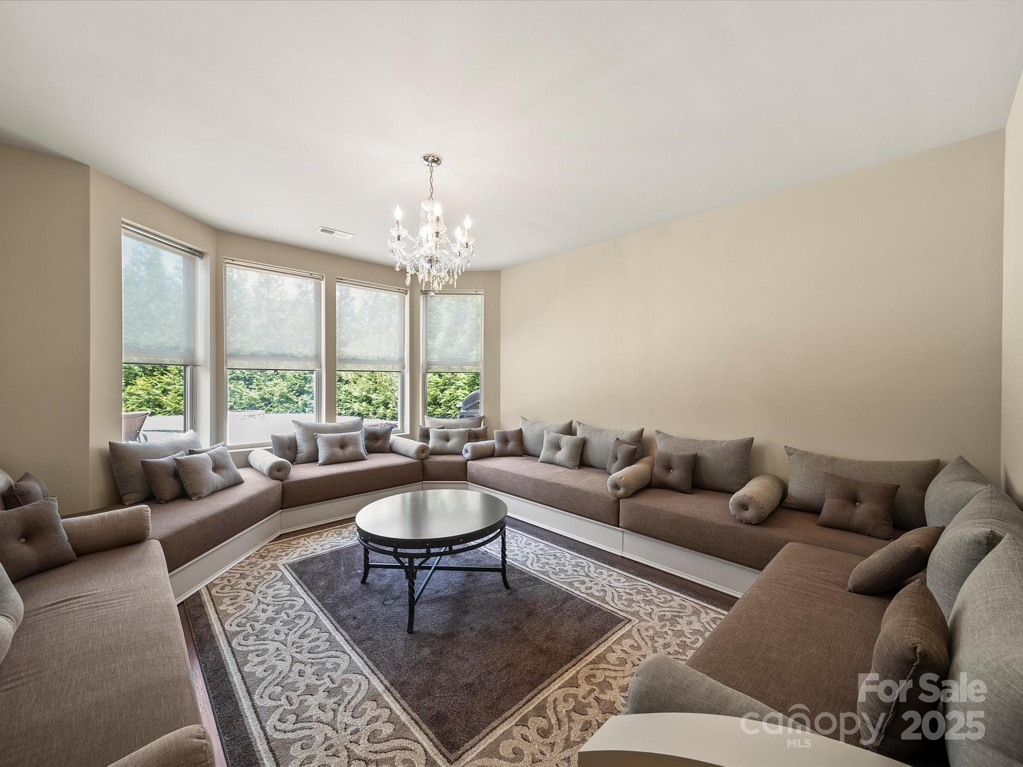11632 Barnard Street Mint Hill, NC 28227 - Photo 27 of 39 a living room with furniture and a chandelier