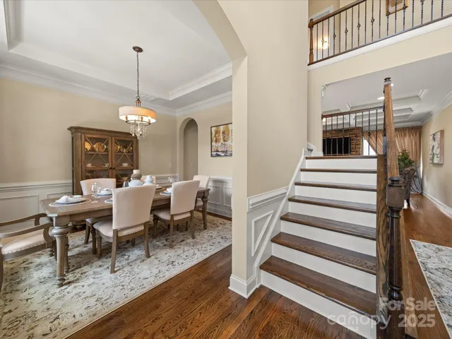 a view of a dining room and hall with wooden floor