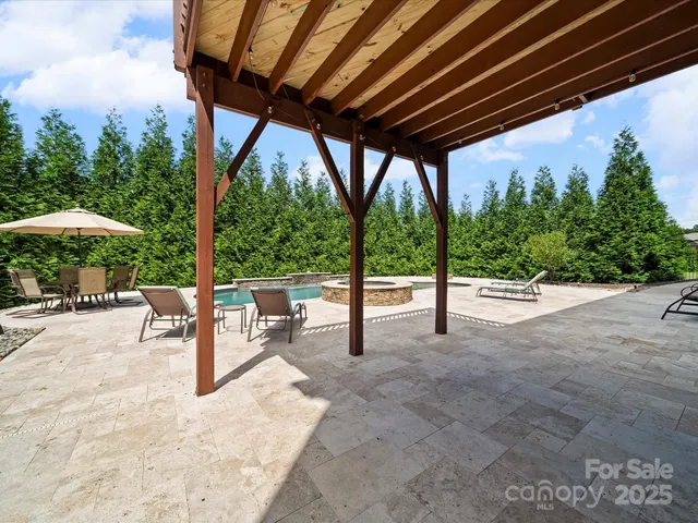 a outdoor sitting area with furniture and a bench