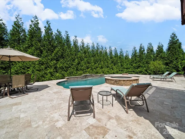 a view of a swimming pool with outdoor seating