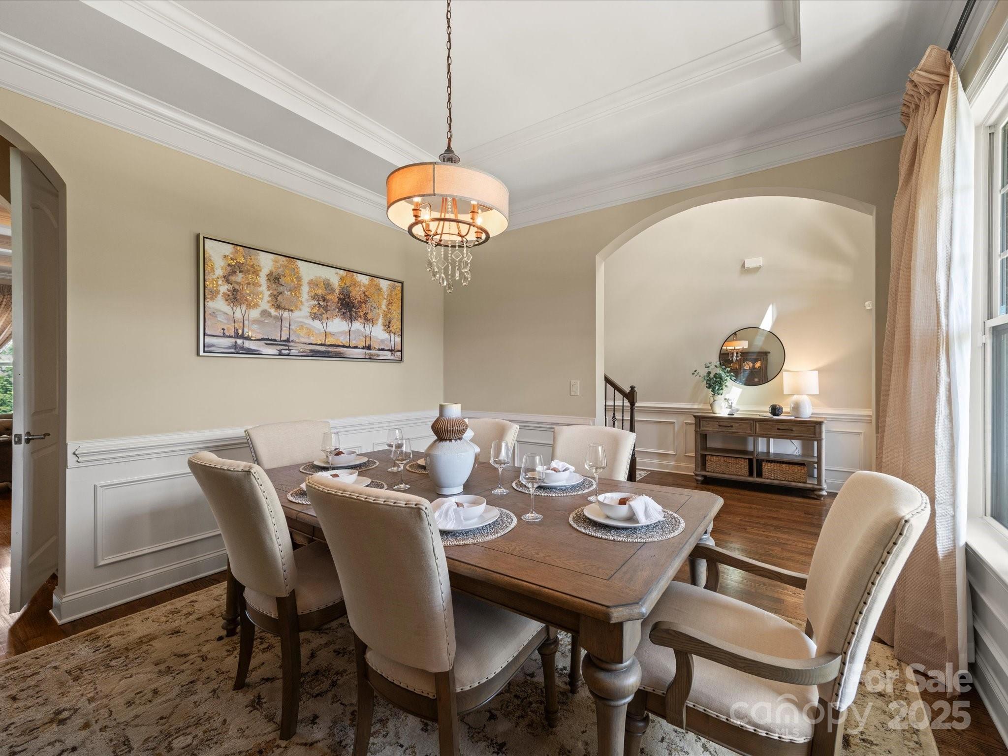 11632 Barnard Street Mint Hill, NC 28227 - Photo 5 of 39 a view of a dining room with furniture a chandelier and wooden floor