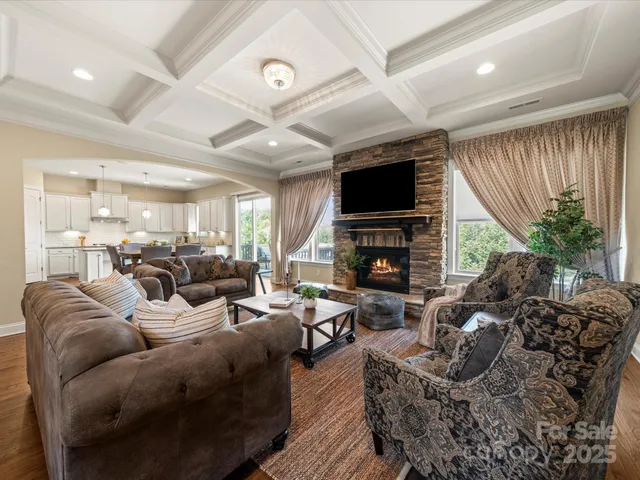 a living room with fireplace furniture and a flat screen tv