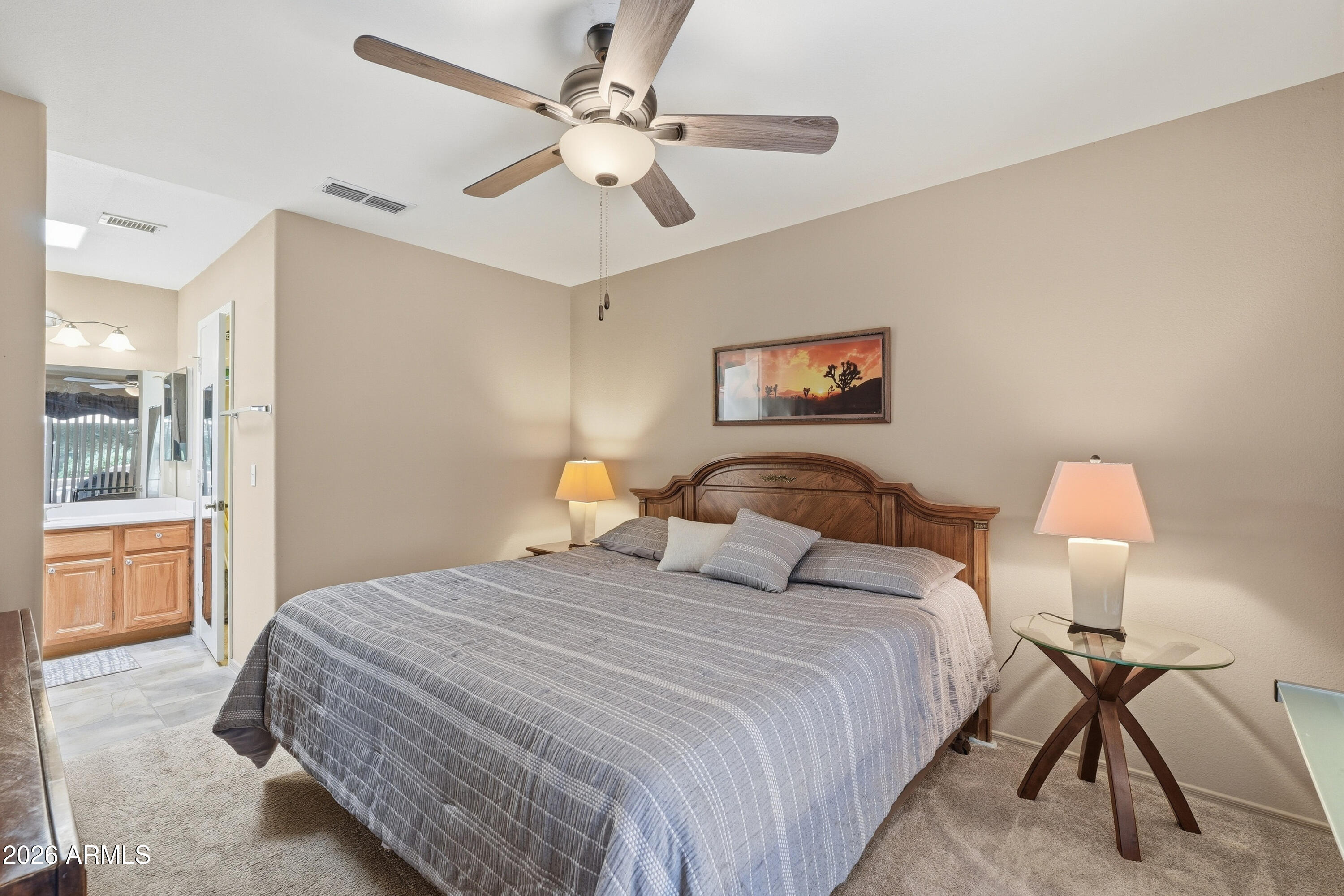 14300 West Bell Road, Unit 387 Surprise, AZ 85374 - Photo 13 of 18 a bedroom with bed and a chandelier
