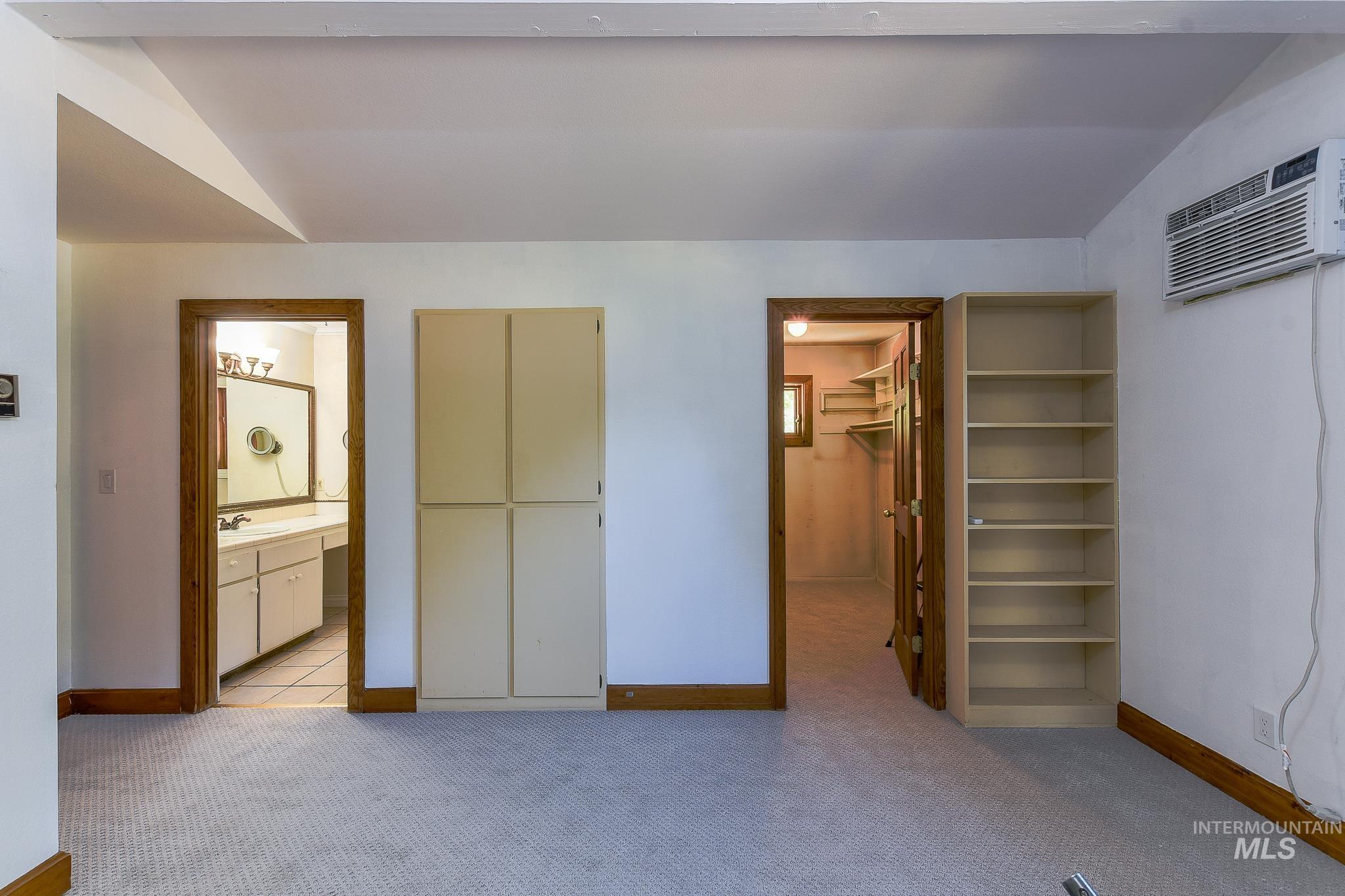 1045 Joyce Road Moscow, ID 83843 - Photo 30 of 50 Carpeted flooring, built-in shelving, and a wall-mounted air conditioning unit