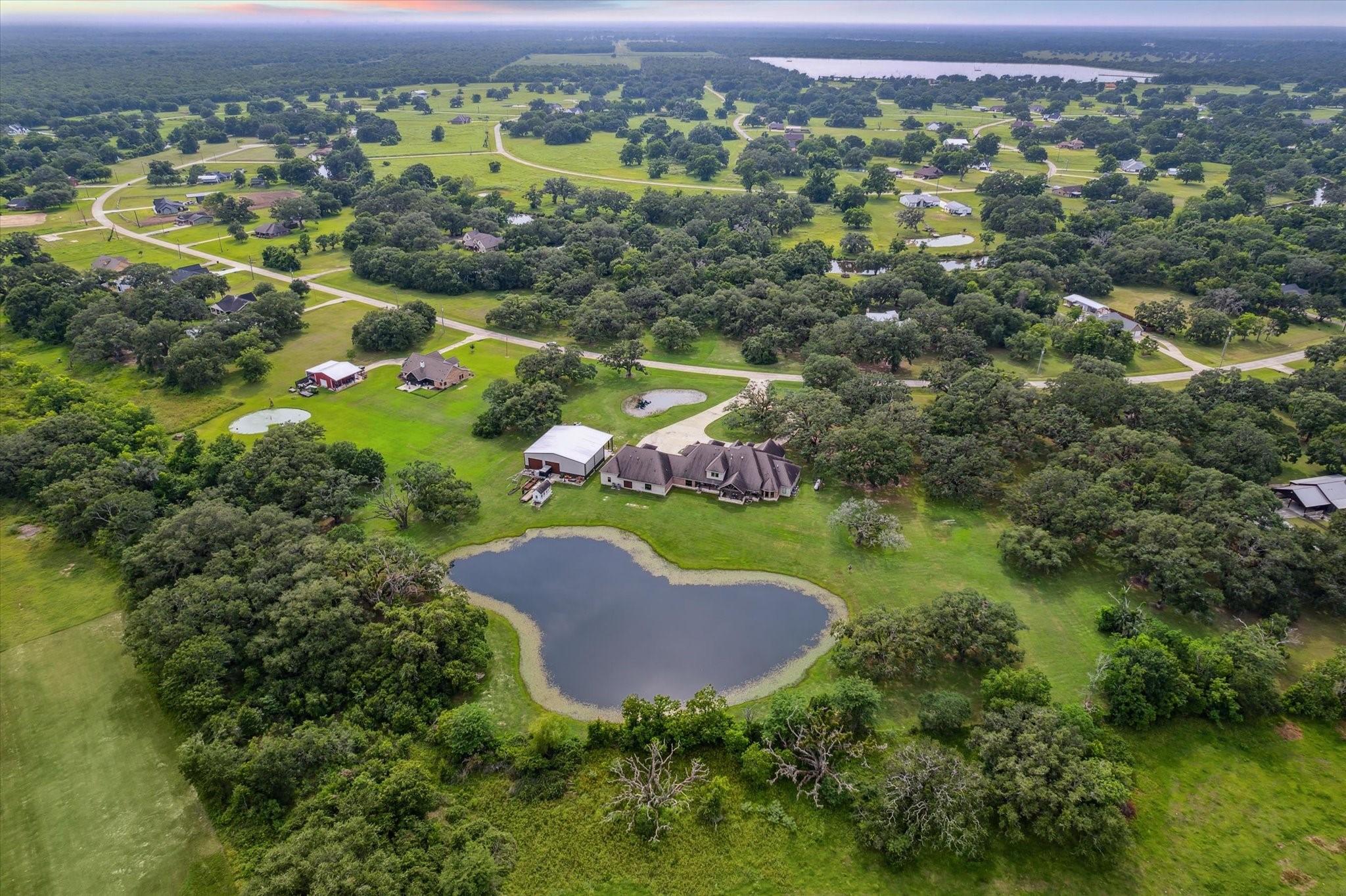 1255 Bronco Trail Angleton, TX 77515 - Photo 47 of 50 Set on 5 acres, this property is a nature lover's paradise, featuring century-old oak trees and two tranquil ponds. The land is teeming with an abundance of wildlife, including deer, bobcats, rabbits, bald eagles, cranes, owls, hawks, foxes, and more. Witness these incredible animals in their natural habitat on a daily basis, offering a serene and ever-changing outdoor landscape. Perfect for those seeking privacy and the beauty of nature right outside their door.