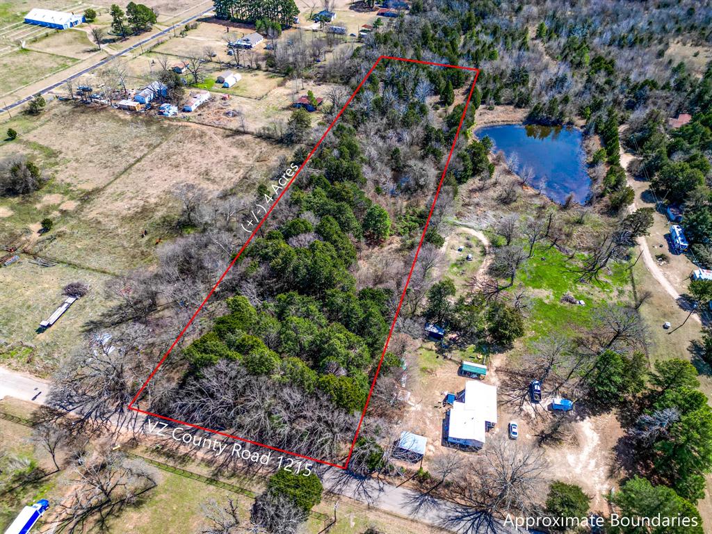 1215 County Road 1215 Canton, TX 75103 - Photo 6 of 8 a view of a wooden house with a yard and plants