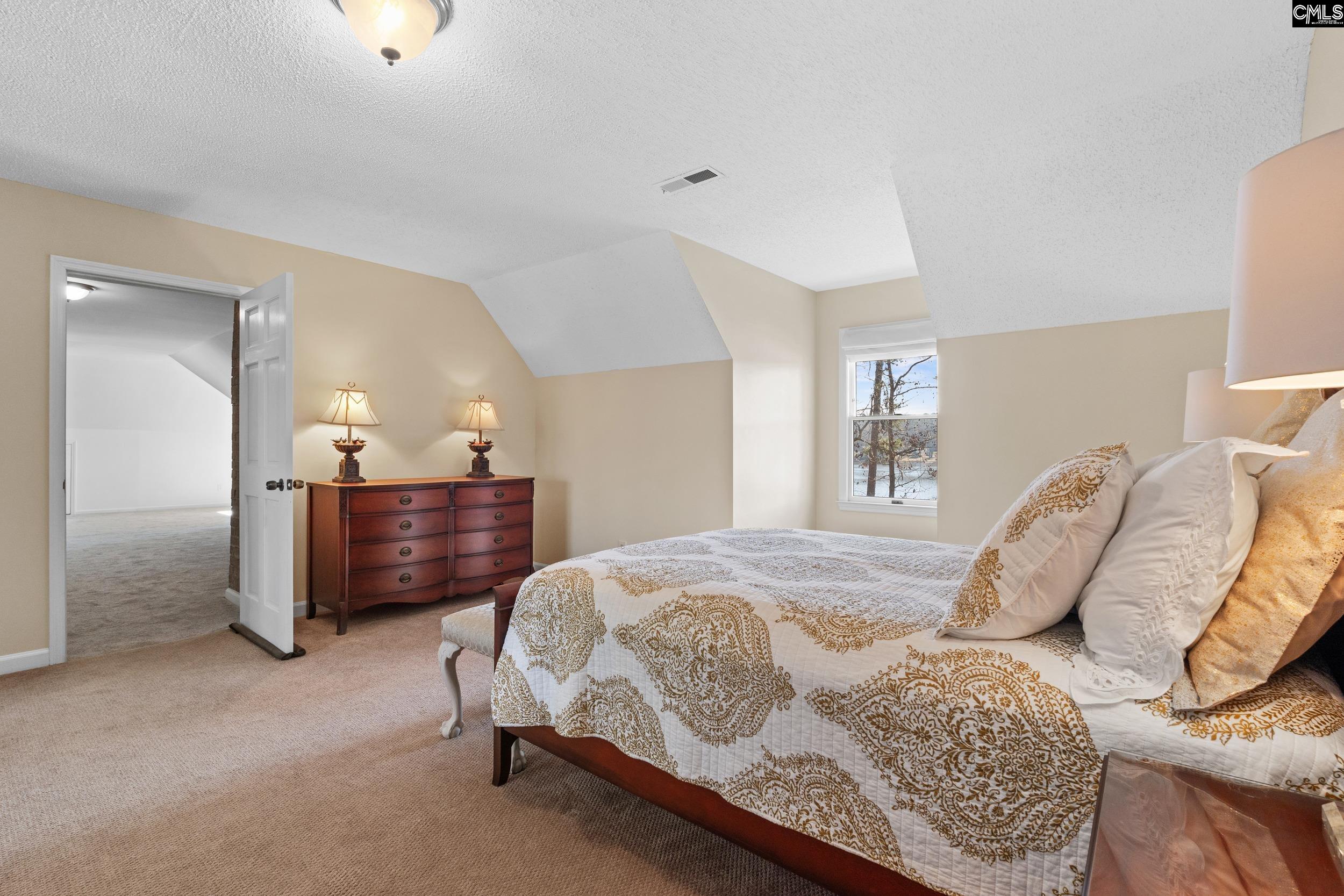 115 Rocky Ridge Road Leesville, SC 29070 - Photo 33 of 51 a bed room with a bed and a chair