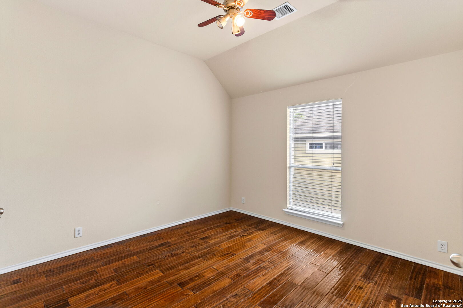6737 Terra Rye San Antonio, TX 78240 - Photo 11 of 26 an empty room with wooden floor fan and windows