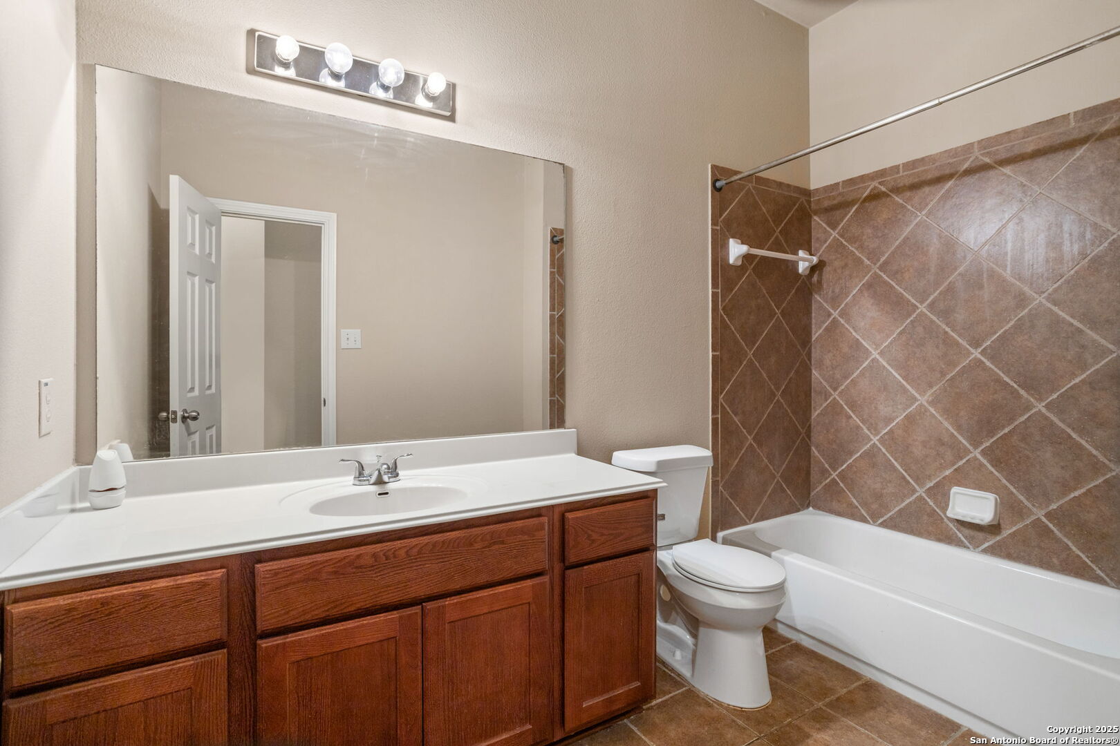 6737 Terra Rye San Antonio, TX 78240 - Photo 12 of 26 a bathroom with a sink a toilet and shower