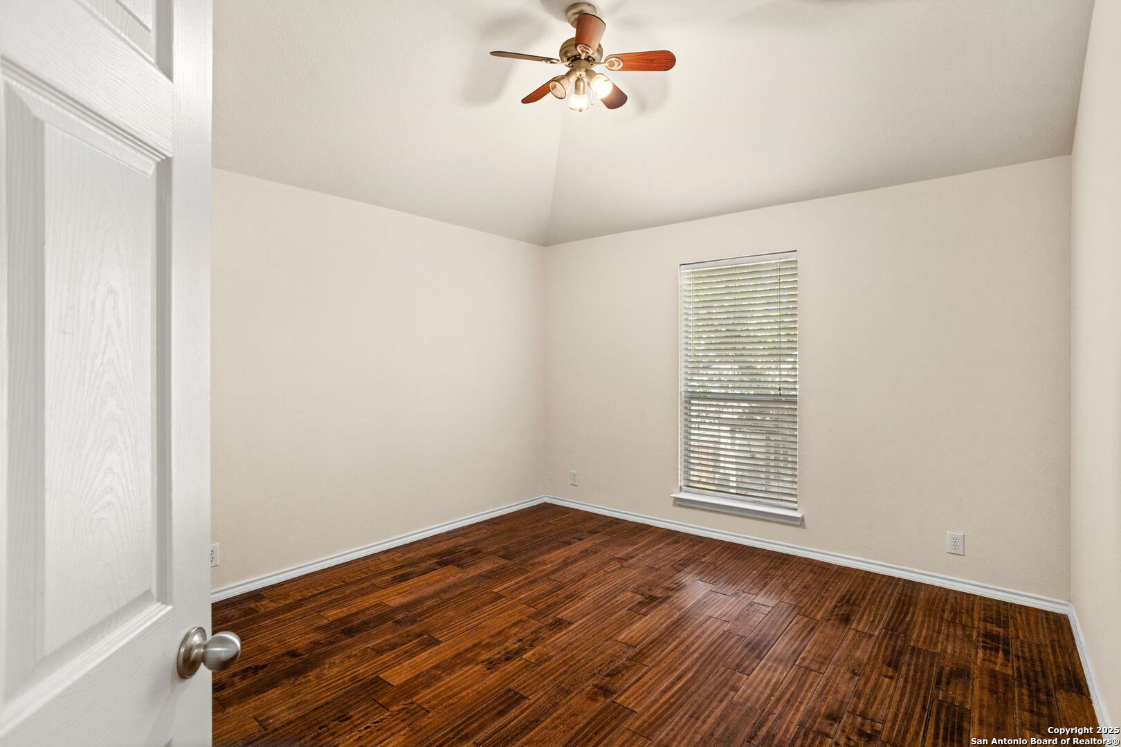 6737 Terra Rye San Antonio, TX 78240 - Photo 13 of 26 an empty room with wooden floor fan and windows