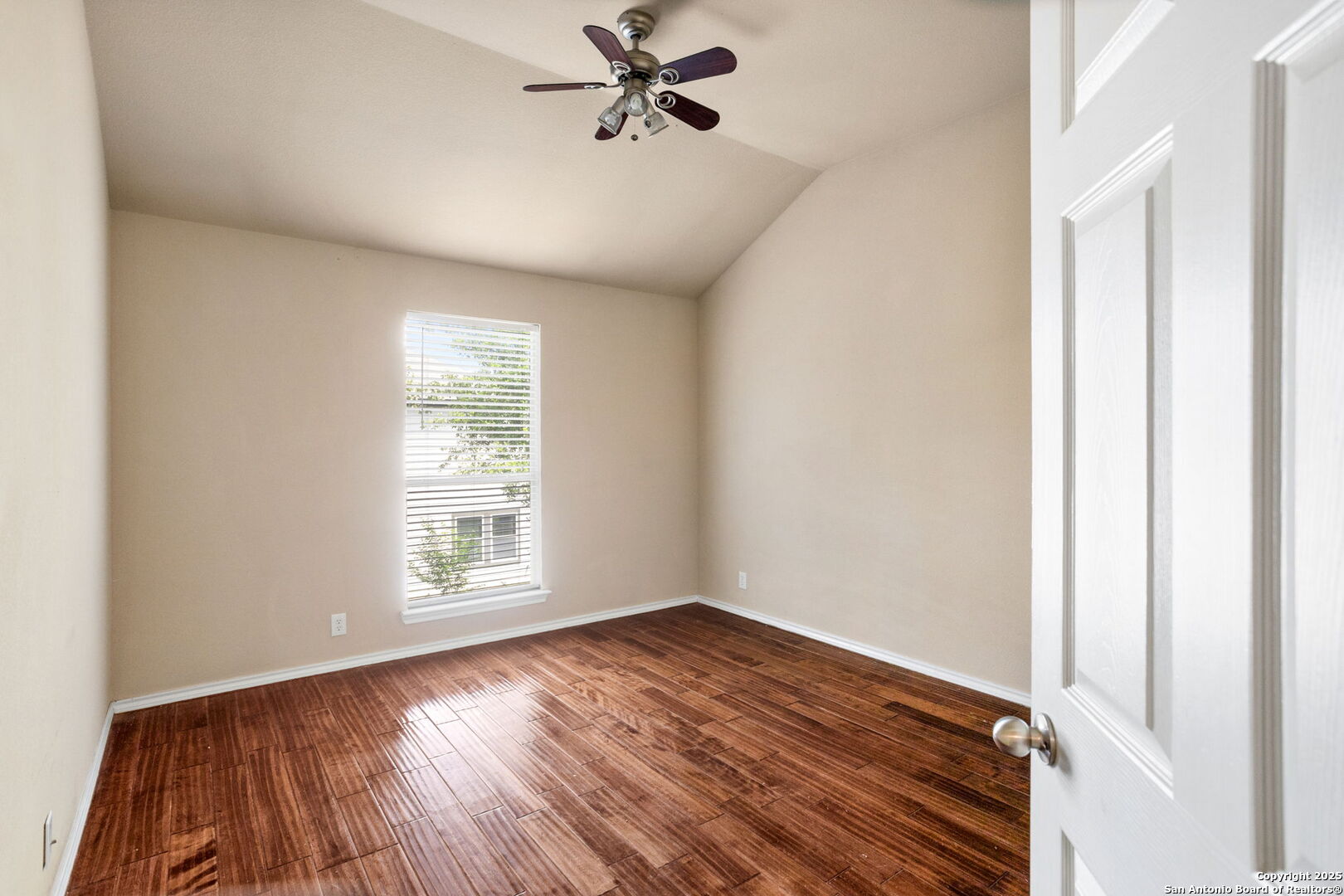 6737 Terra Rye San Antonio, TX 78240 - Photo 14 of 26 an empty room with wooden floor fan and windows