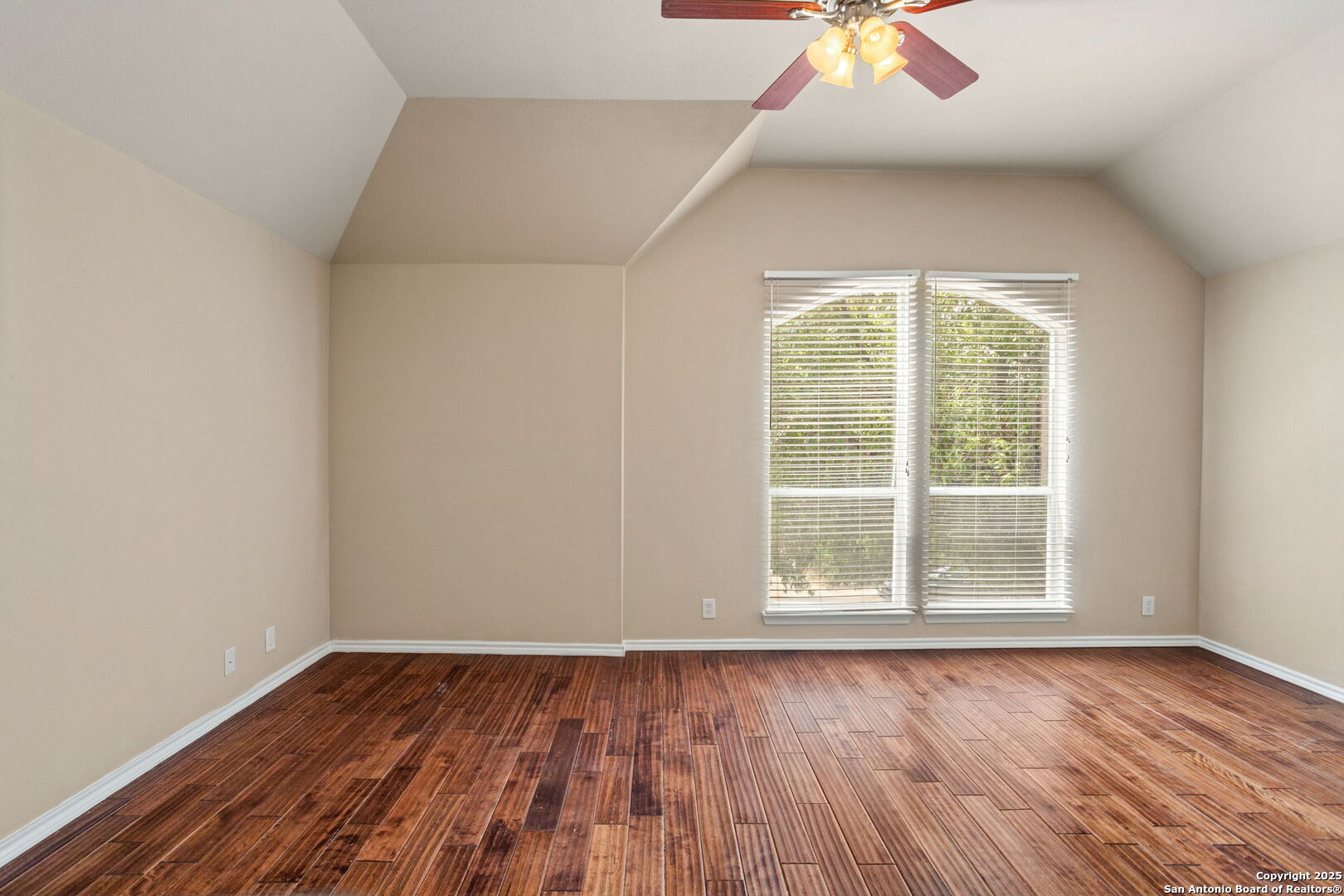 6737 Terra Rye San Antonio, TX 78240 - Photo 16 of 26 an empty room with wooden floor and windows