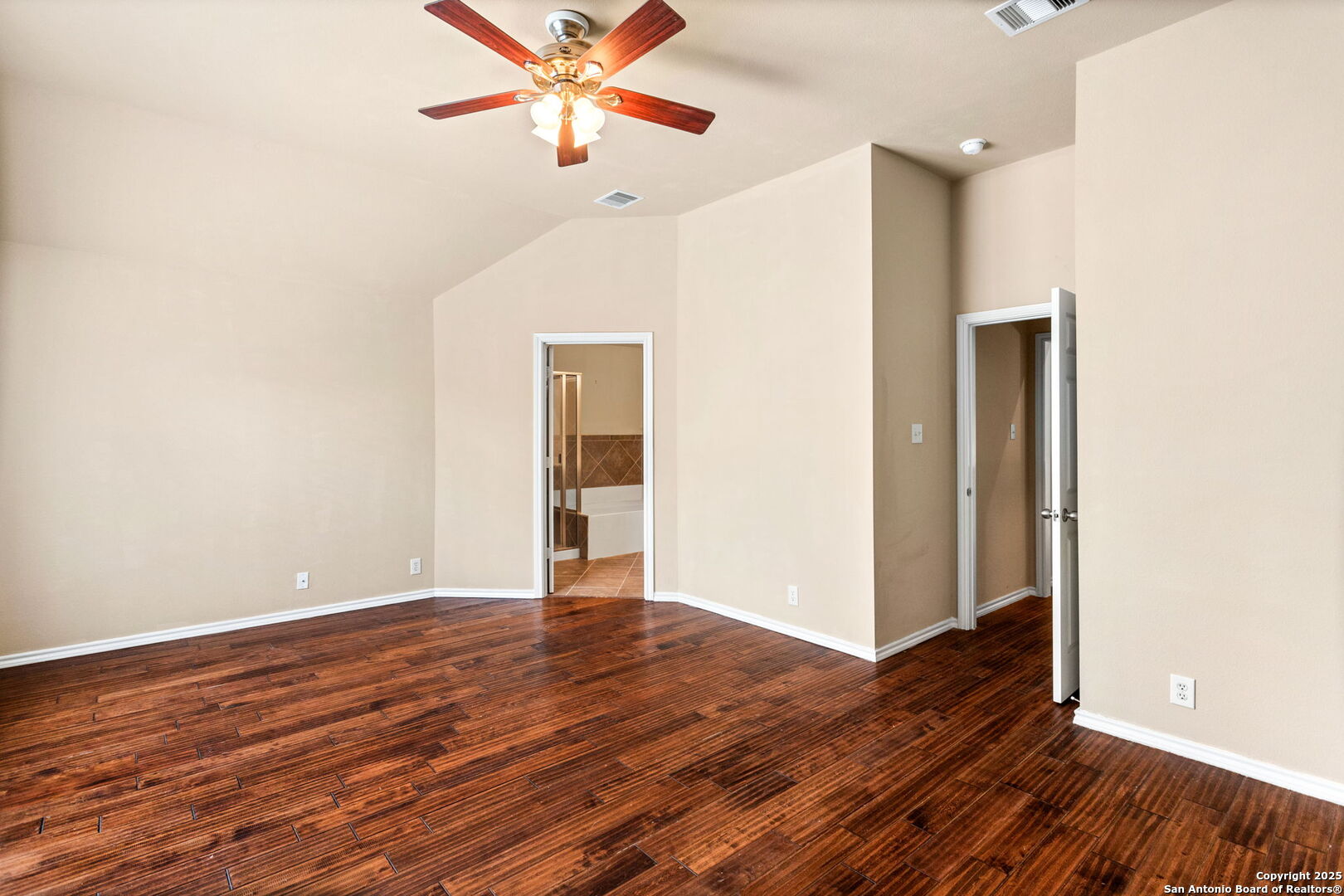 6737 Terra Rye San Antonio, TX 78240 - Photo 17 of 26 an empty room with wooden floor chandelier fan and windows