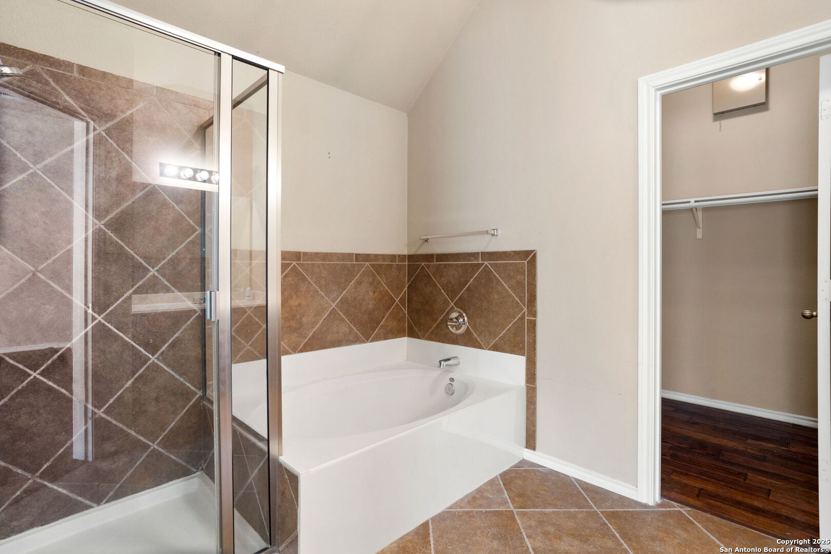 6737 Terra Rye San Antonio, TX 78240 - Photo 19 of 26 a bathroom with a bathtub and a shower