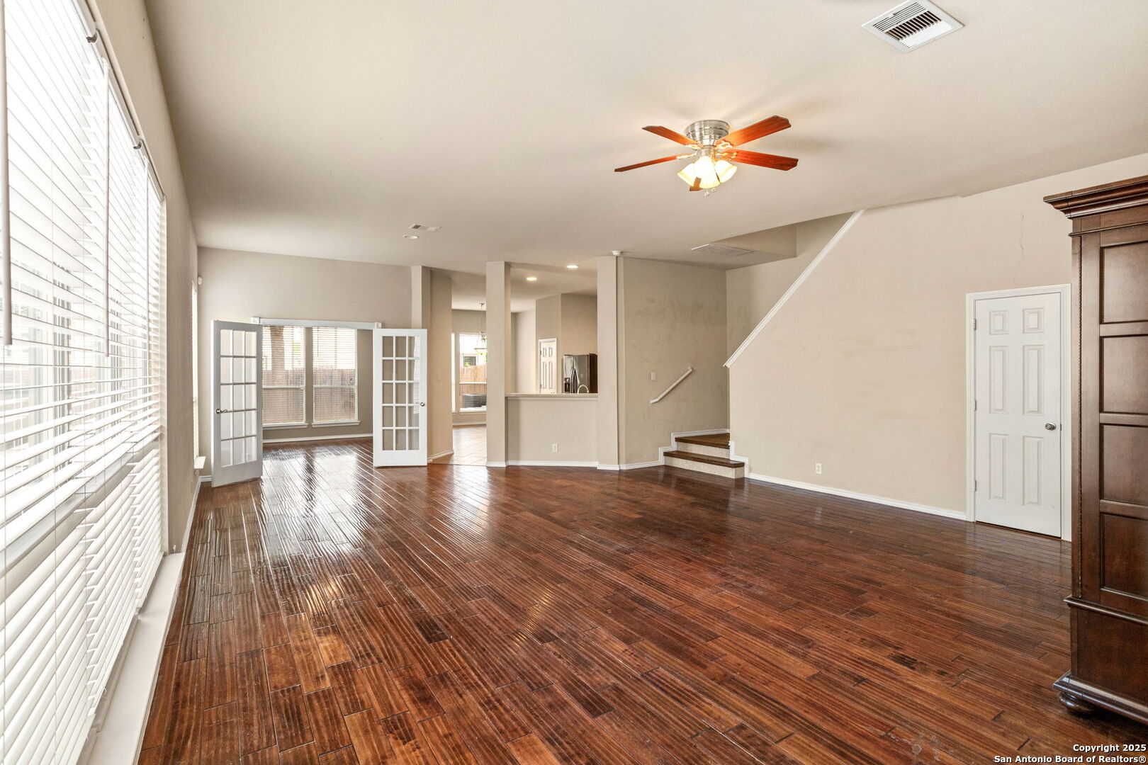 6737 Terra Rye San Antonio, TX 78240 - Photo 2 of 26 a view of an empty room with wooden floor and a window