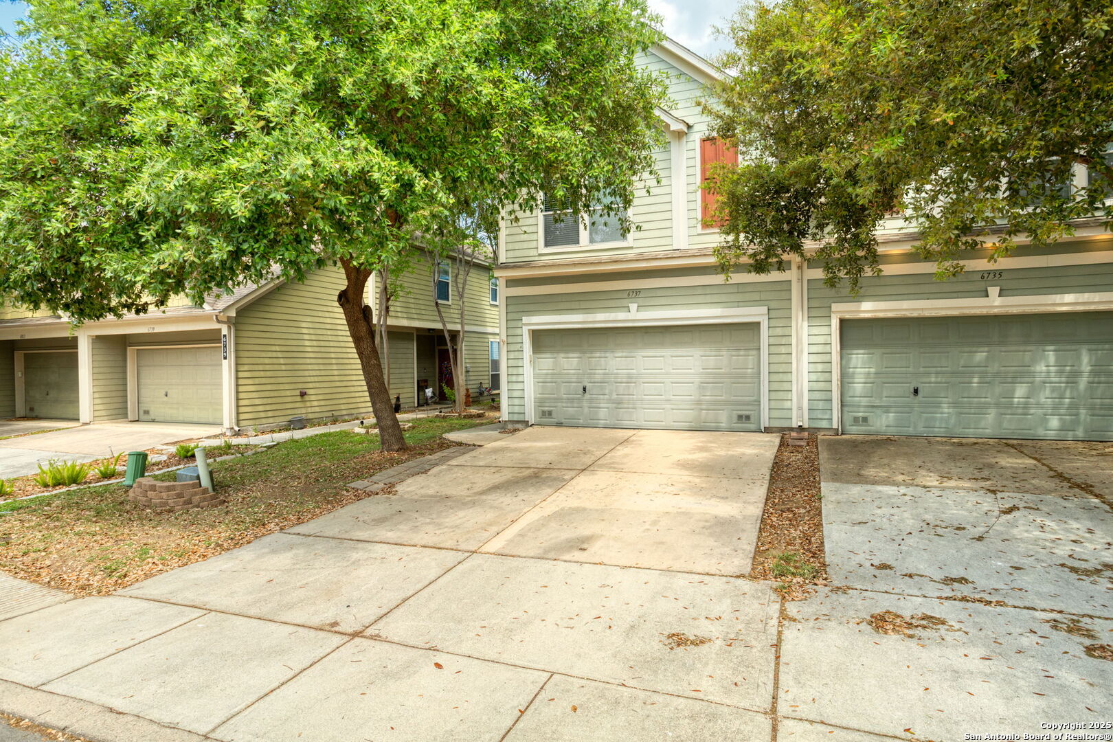 6737 Terra Rye San Antonio, TX 78240 - Photo 25 of 26 a view of a house with a yard and large tree