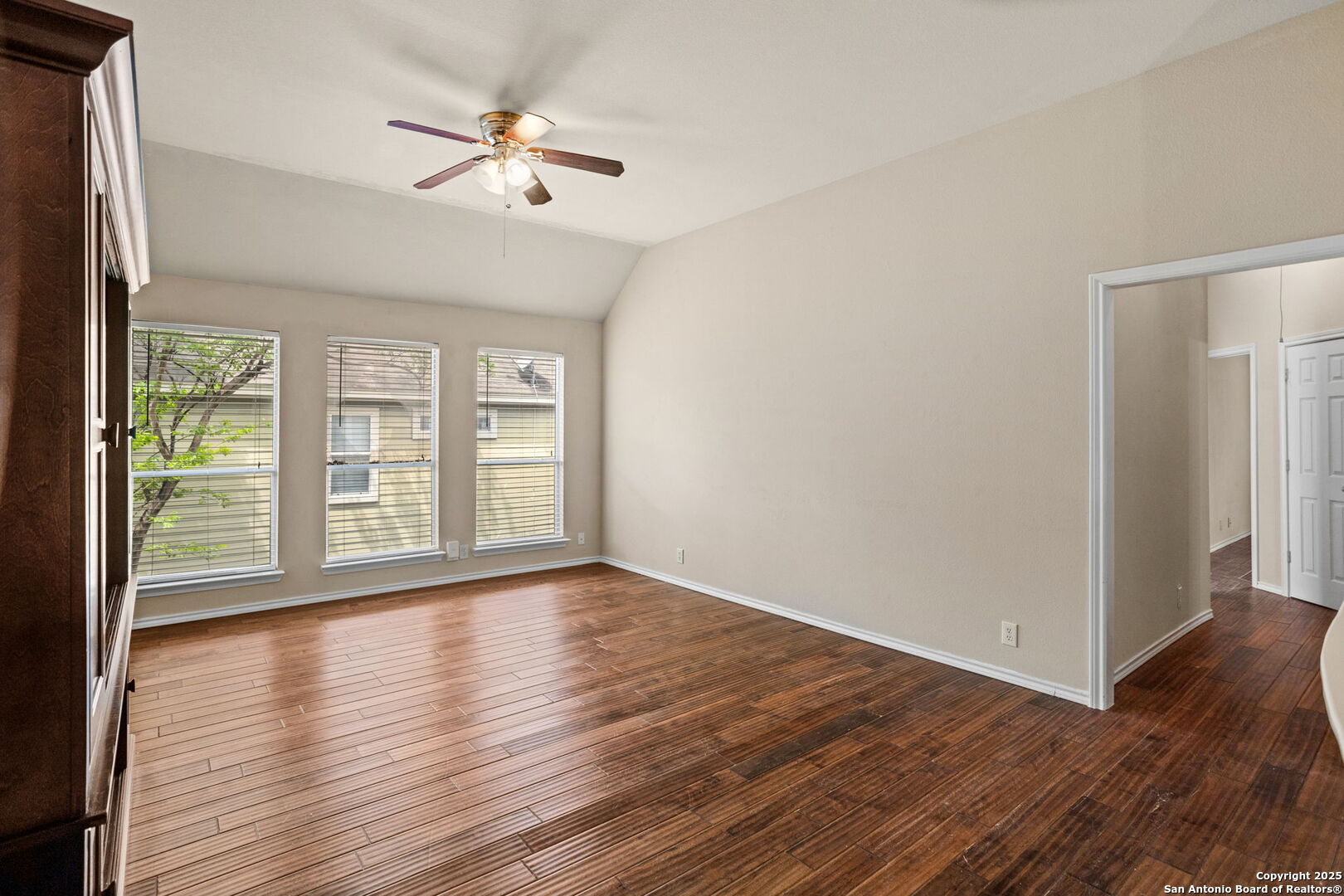 6737 Terra Rye San Antonio, TX 78240 - Photo 9 of 26 a view of an empty room with wooden floor and a window