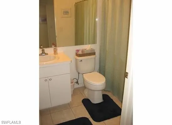 a bathroom with a toilet a sink and a mirror