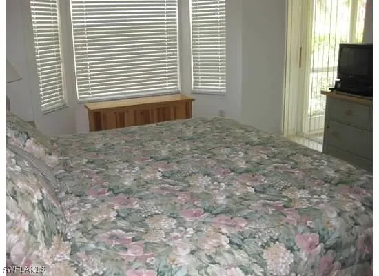 a view of an empty room with a kitchen