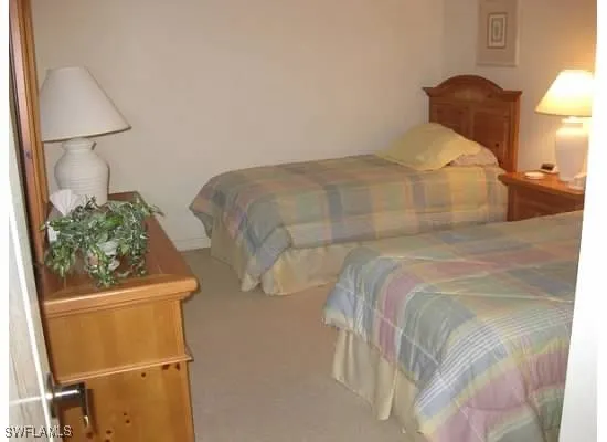 a bedroom with a bed and a lamp