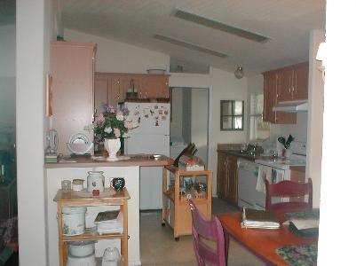 34 Bluejay Drive, Unit 34 Santa Rosa, CA 95409 - Photo 4 of 5 a room with a wooden floor and cabinets