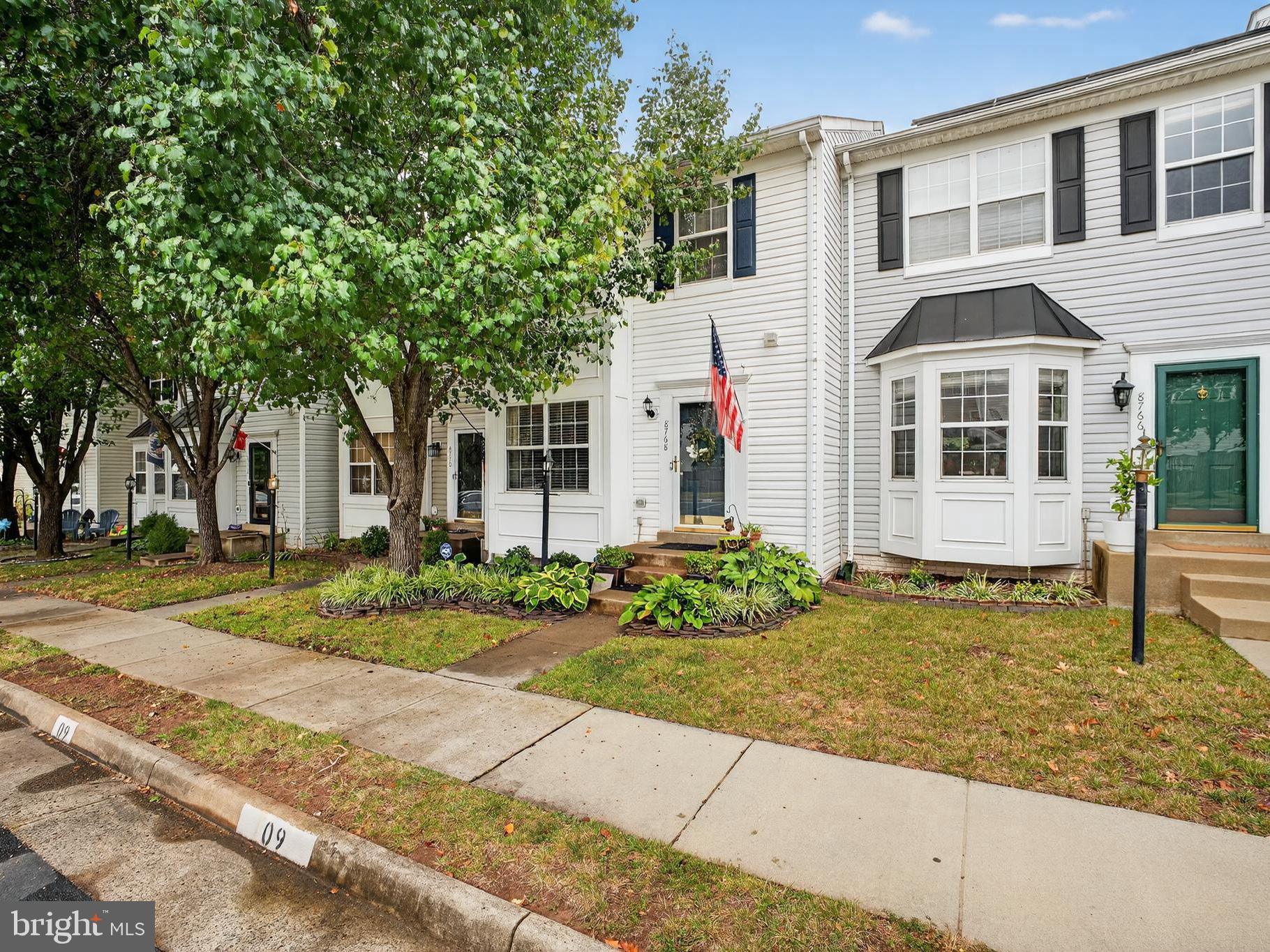 8768 Dunstable Loop Bristow, VA 20136 - Photo 2 of 47 a front view of a house with a garden and plants