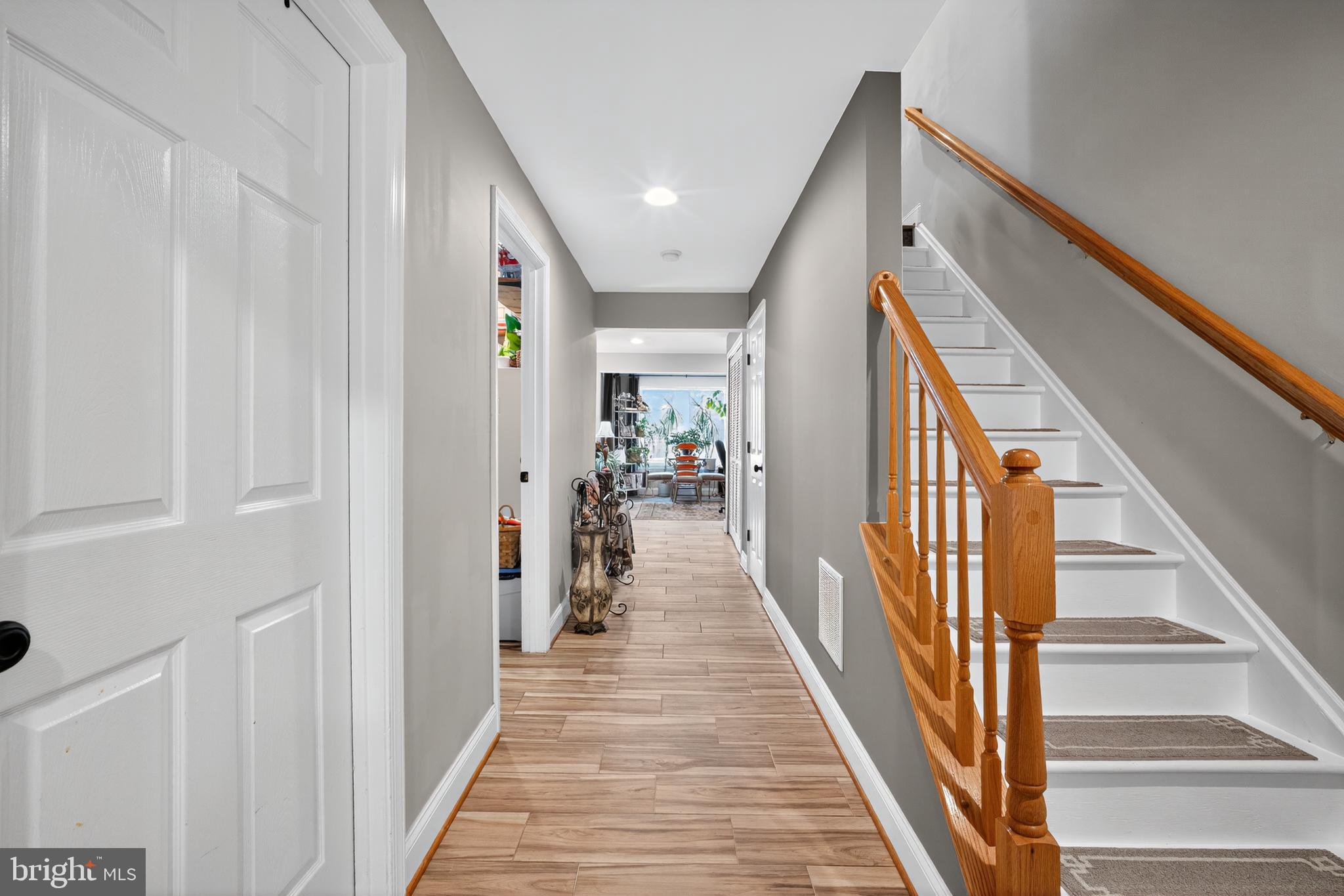 8768 Dunstable Loop Bristow, VA 20136 - Photo 23 of 47 a view of a hallway with wooden floor and staircase