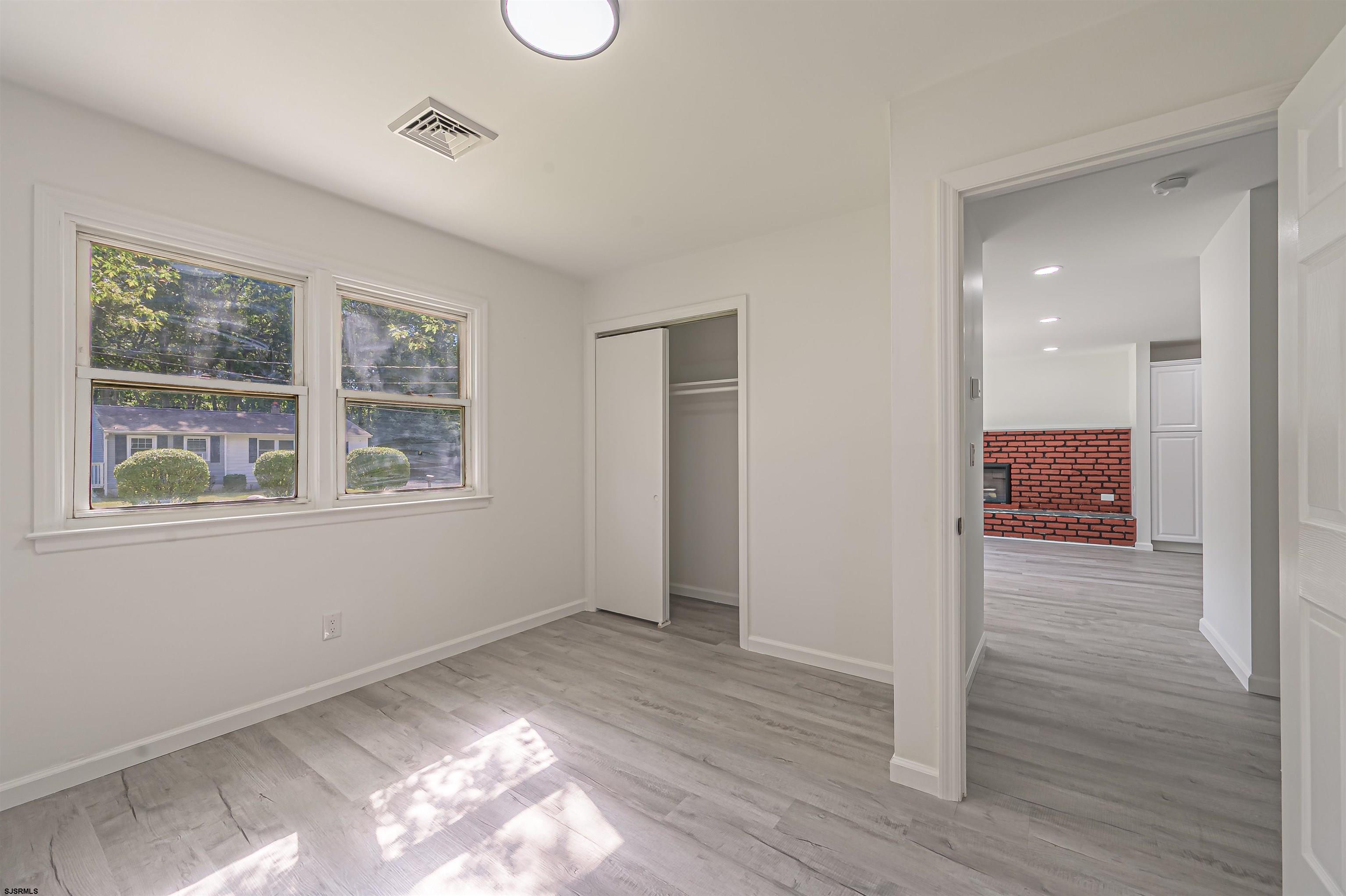 25 Robin Road Egg Harbor Township, NJ 08234 - Photo 13 of 24 a view of a room with wooden floor and window