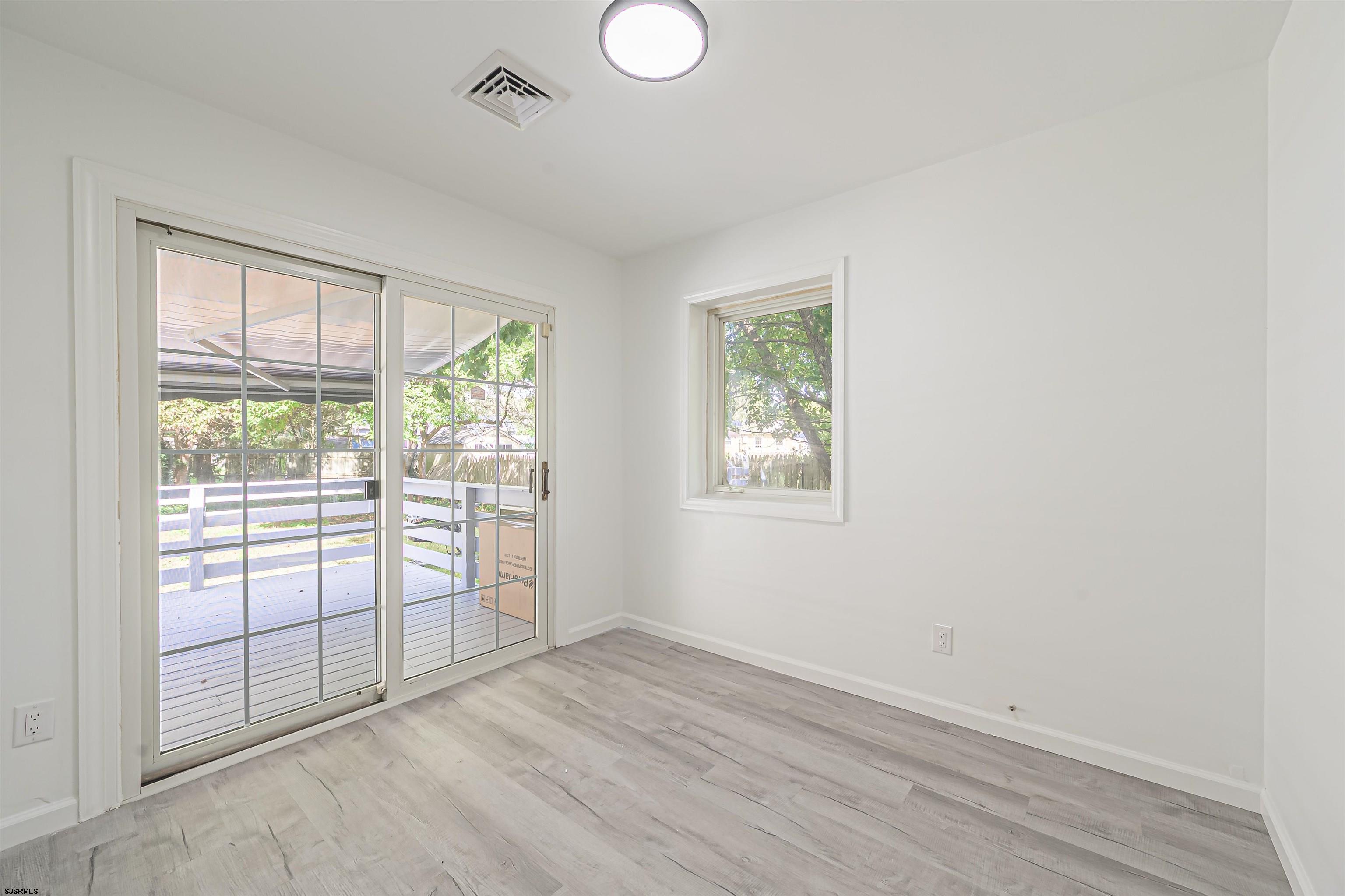 25 Robin Road Egg Harbor Township, NJ 08234 - Photo 15 of 24 an empty room with wooden floor and windows