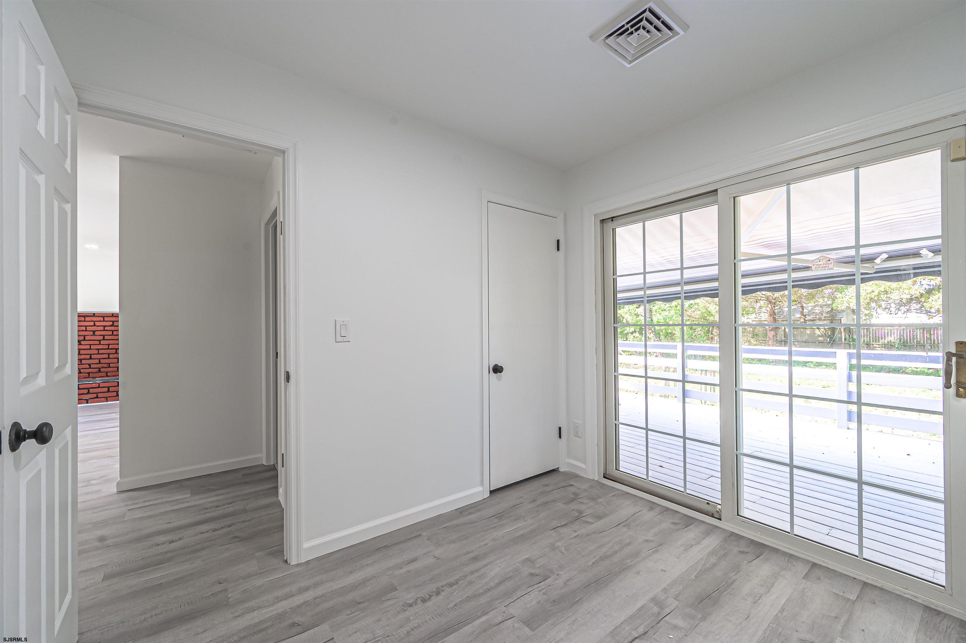25 Robin Road Egg Harbor Township, NJ 08234 - Photo 16 of 24 an empty room with wooden floor and windows
