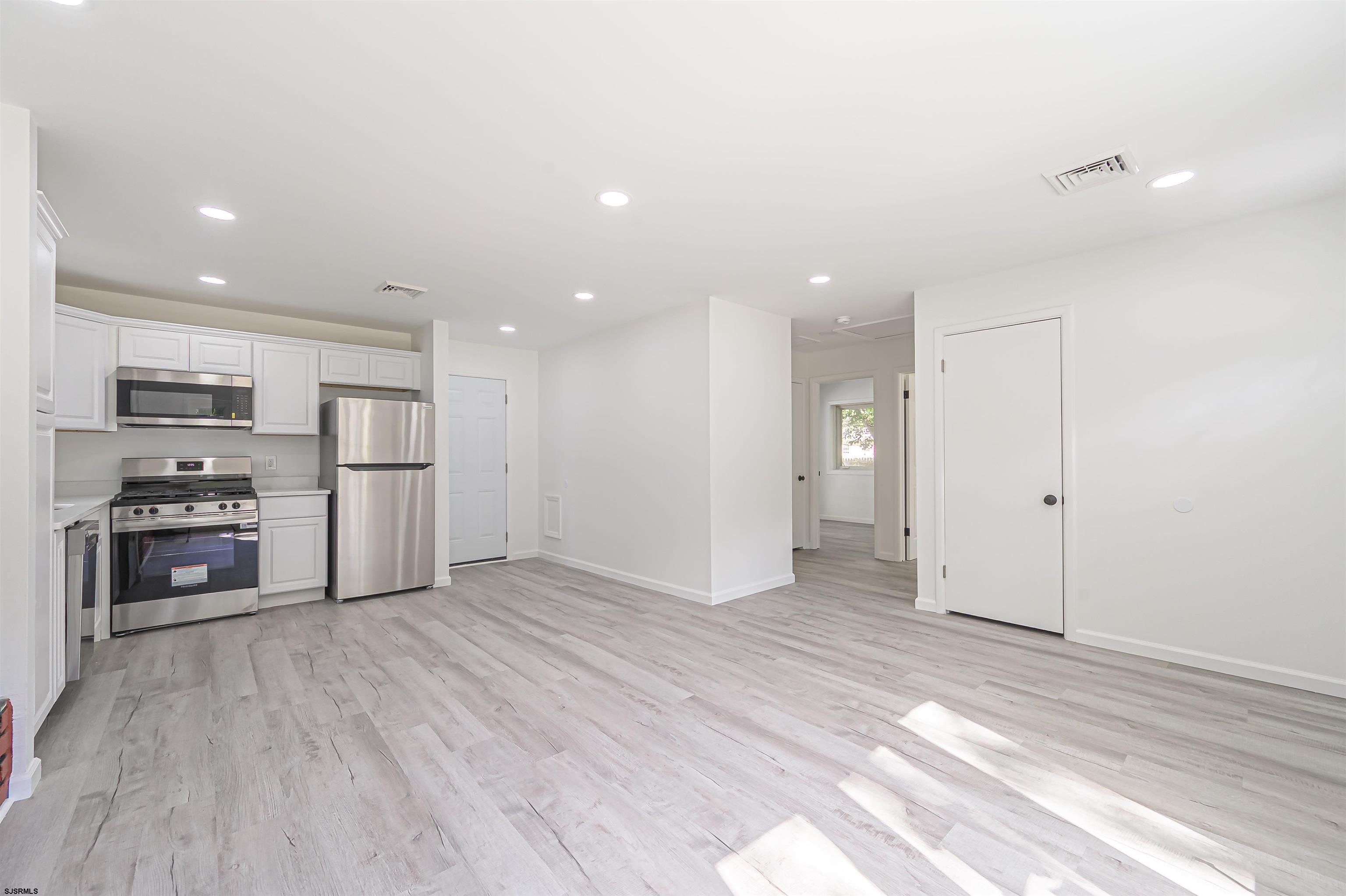 25 Robin Road Egg Harbor Township, NJ 08234 - Photo 4 of 24 a view of kitchen with stainless steel appliances refrigerator stove microwave and cabinets