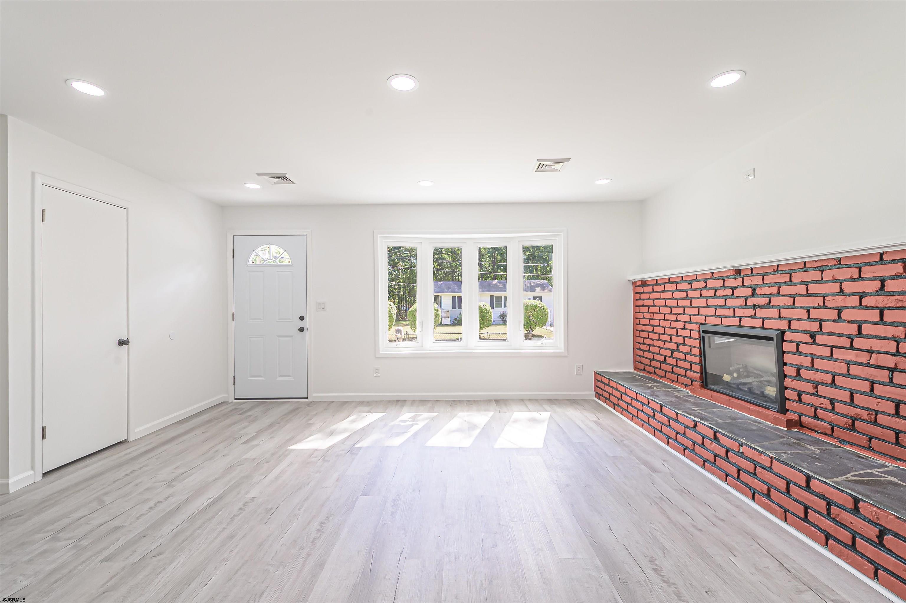 25 Robin Road Egg Harbor Township, NJ 08234 - Photo 8 of 24 an empty room with wooden floor and windows