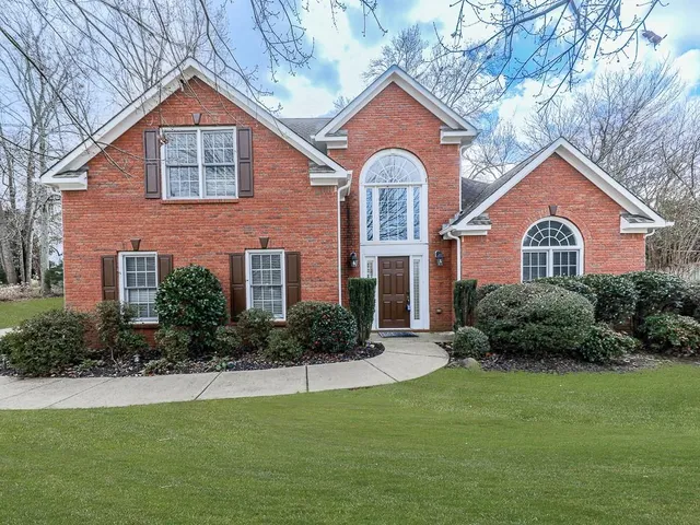 a front view of a house with a yard