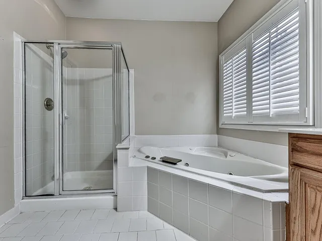 a bathroom with a tub sink and shower